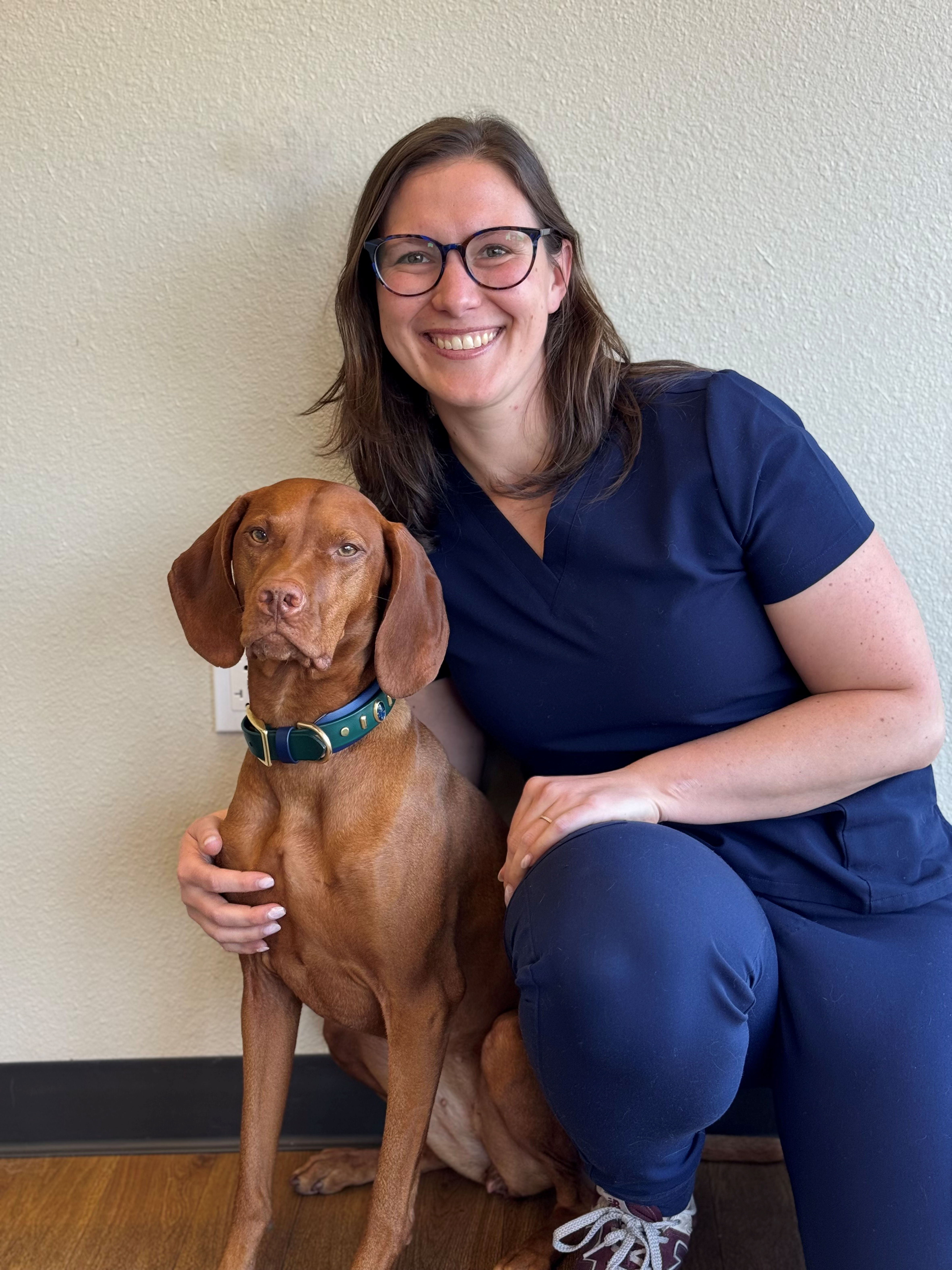 Dr. Nilanthi Vipuli Kulasekara Veterinarian at Urgent Pet Doctor Headshot holding puppy